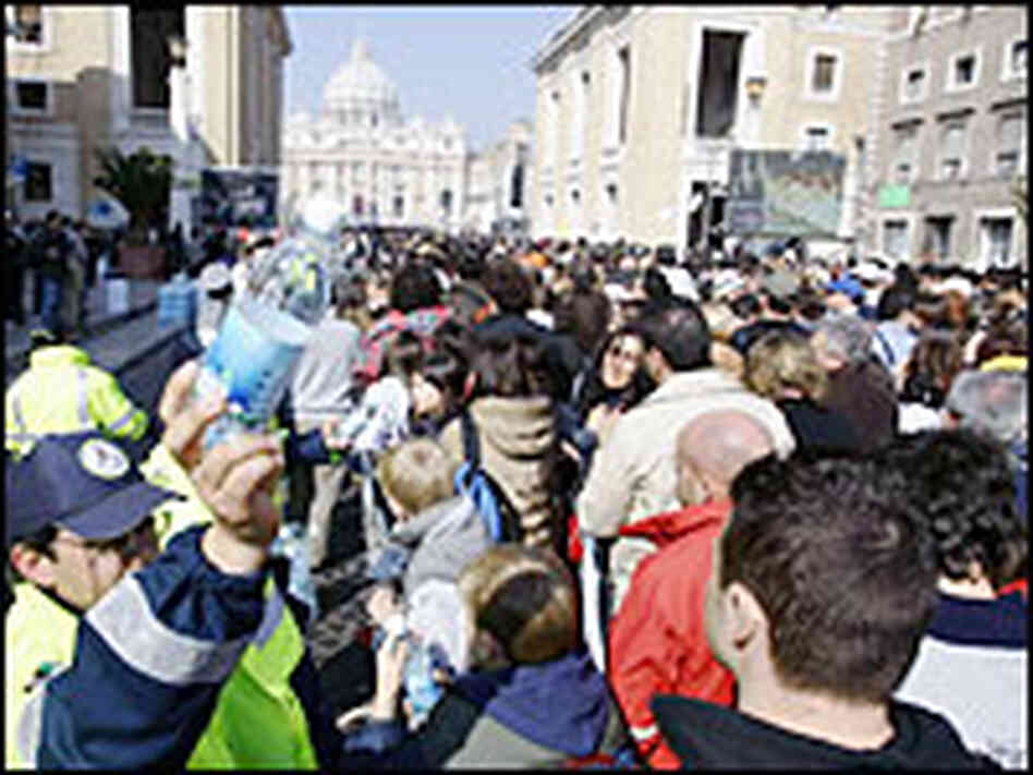 Bottles of drinking water are distributed to people in line to view the body of Pope John Paul II Bottles of drinking water are distributed to people in line to view the body of Pope John Paul II