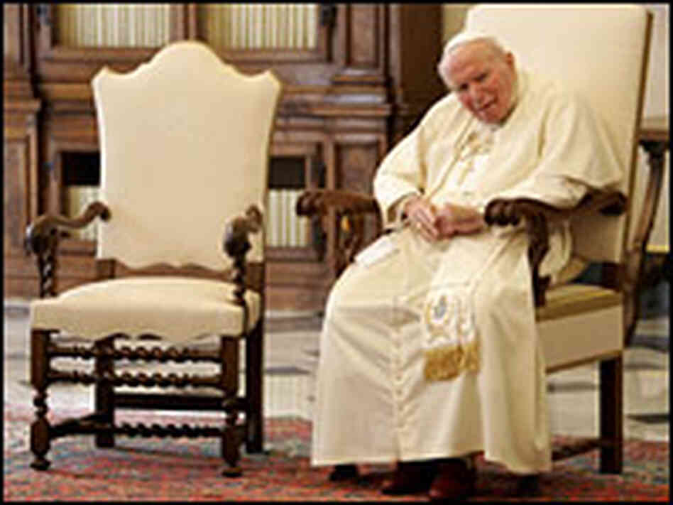 Pope John Paul II, seated at the Vatican. Pope John Paul II, seated at the Vatican.