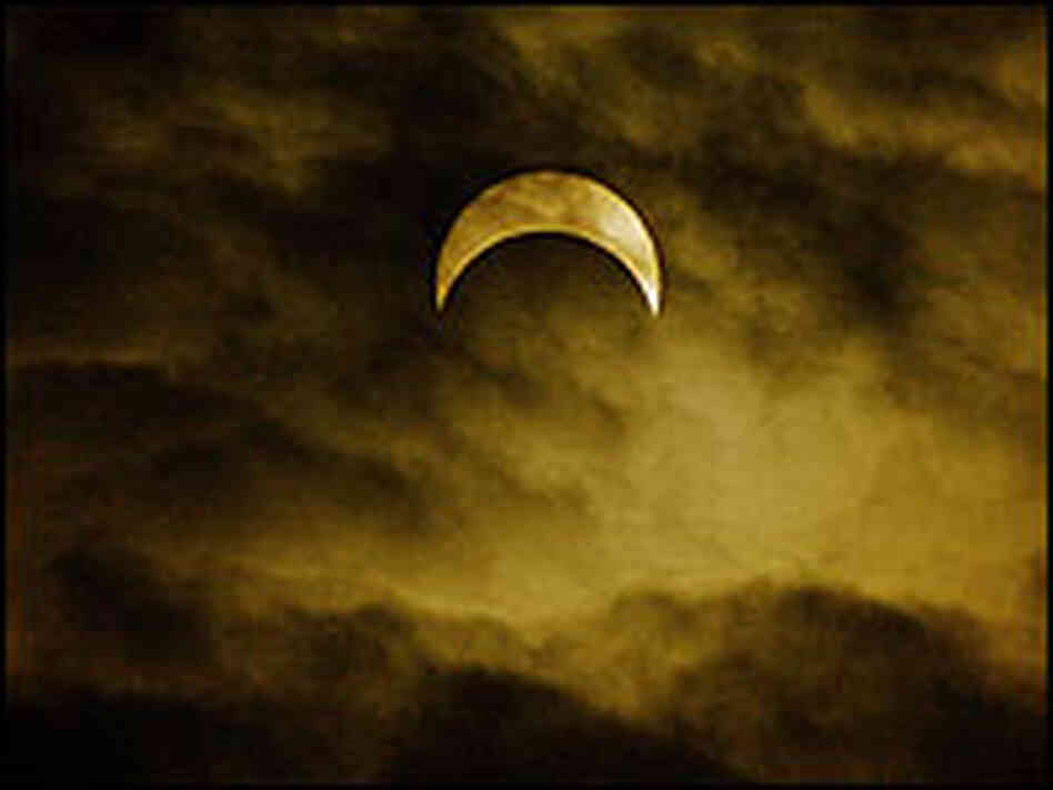 The moon passes between the earth and the sun to cause an eclipse in Bogota, Colombia. The moon passes between the earth and the sun to cause an eclipse in Bogota, Colombia.
