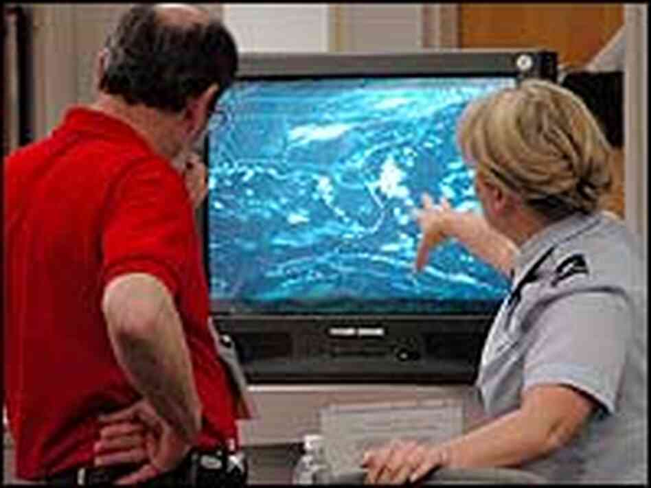 U.S. Air Force Lt. Col. Maria Carl points to a radar screen which shows bad weather off Florida. U.S. Air Force Lt. Col. Maria Carl points to a radar screen which shows bad weather off Florida.