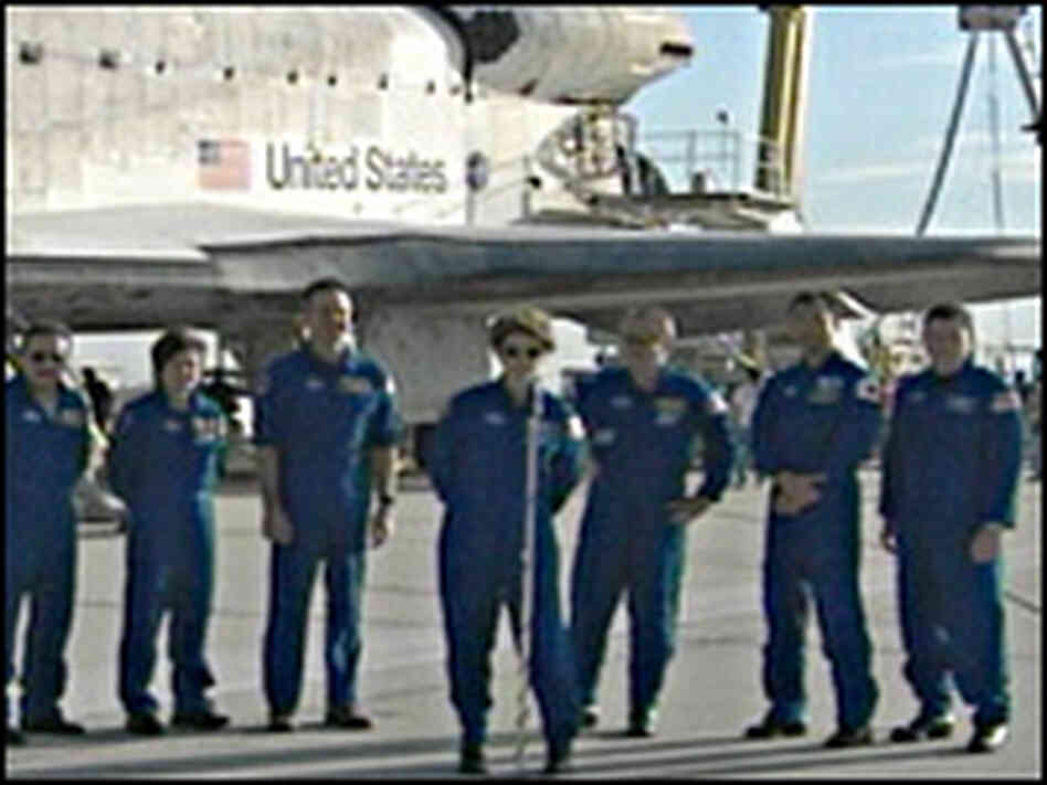 Eileen Collins, commander of of the STS-114 mission, stands with members of the Discovery crew as s Eileen Collins, commander of of the STS-114 mission, stands with members of the Discovery crew as s