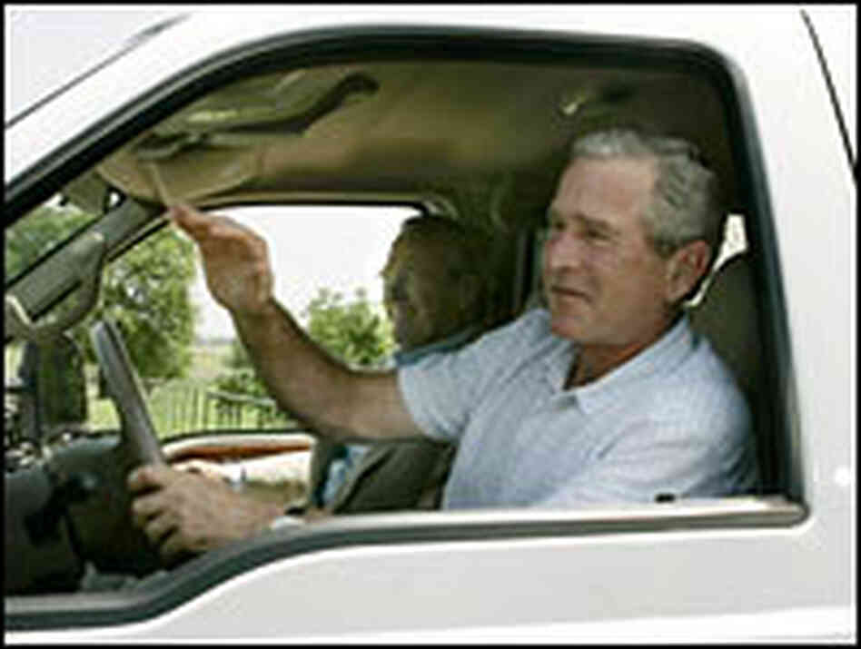 President Bush drives a pickup truck as Defense Secretary Donald Rumsfeld rides along. President Bush drives a pickup truck as Defense Secretary Donald Rumsfeld rides along.