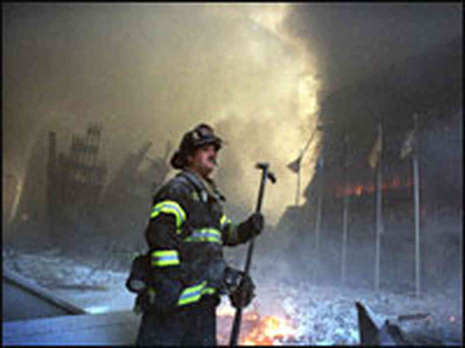 A firefighter stands in the smoking ruins of the World Trade Center A firefighter stands in the smoking ruins of the World Trade Center