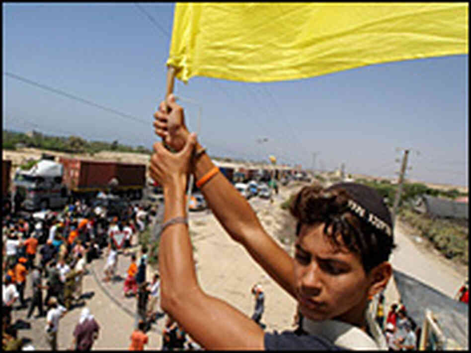 A Jewish settler waves a flag. A Jewish settler waves a flag.