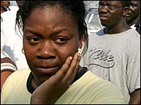Nakita Meeks stands in line at a drug store to buy items in Biloxi, Miss.