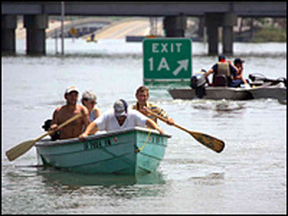 Members of search and rescue teams help evacuate people trapped in flooded homes in New Orleans. Members of search and rescue teams help evacuate people trapped in flooded homes in New Orleans.
