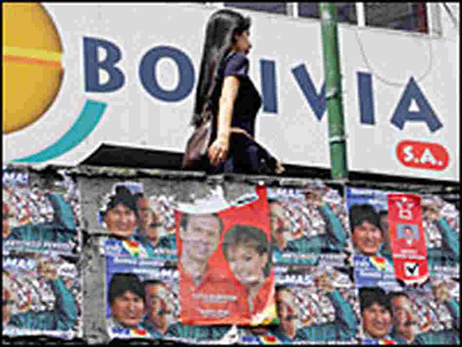 A Bolivian woman walks near election posters in La Paz A Bolivian woman walks near election posters in La Paz