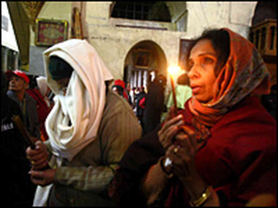Christian pilgrims pray at the Church of Nativity in Bethlehem Christian pilgrims pray at the Church of Nativity in Bethlehem