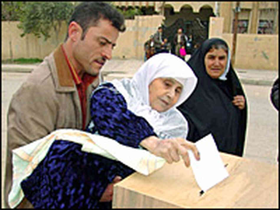 An Iraqi man carries his elderly mother as she casts her vote. Reuters An Iraqi man carries his elderly mother as she casts her vote. Reuters