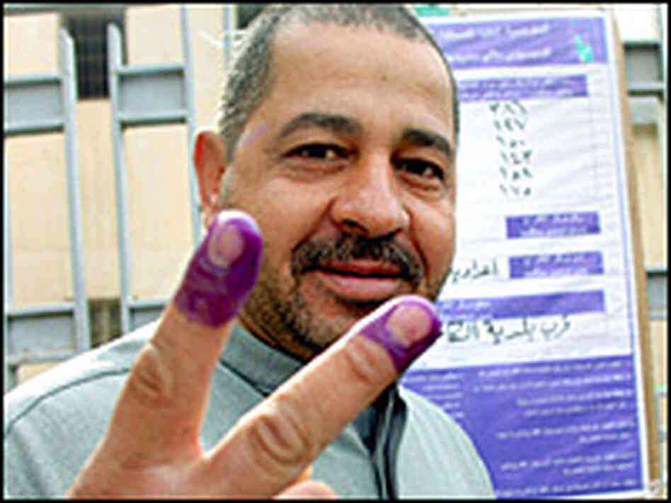 An Iraqi man holds up his stained fingers after voting in his country's national elections.Reuters An Iraqi man holds up his stained fingers after voting in his country's national elections.Reuters