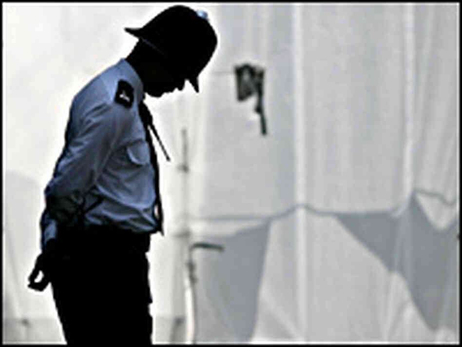 A policeman observes a two-minute silence in memory of the victims of the London bombing. A policeman observes a two-minute silence in memory of the victims of the London bombing.