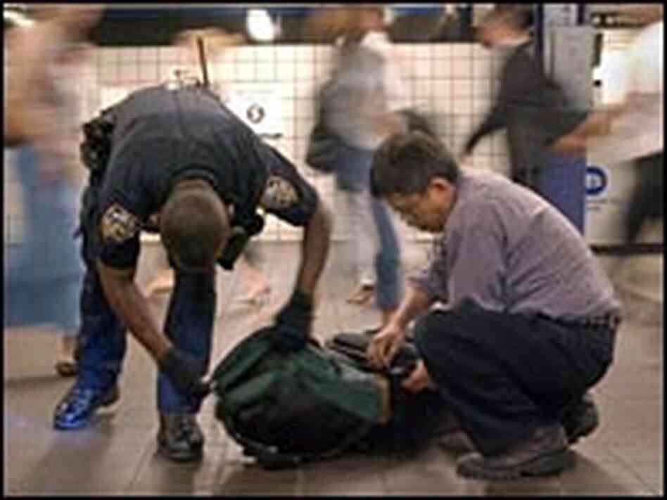 Police officer Russell King inspects bags at the 42nd Street Port Authority subway station. Police officer Russell King inspects bags at the 42nd Street Port Authority subway station.