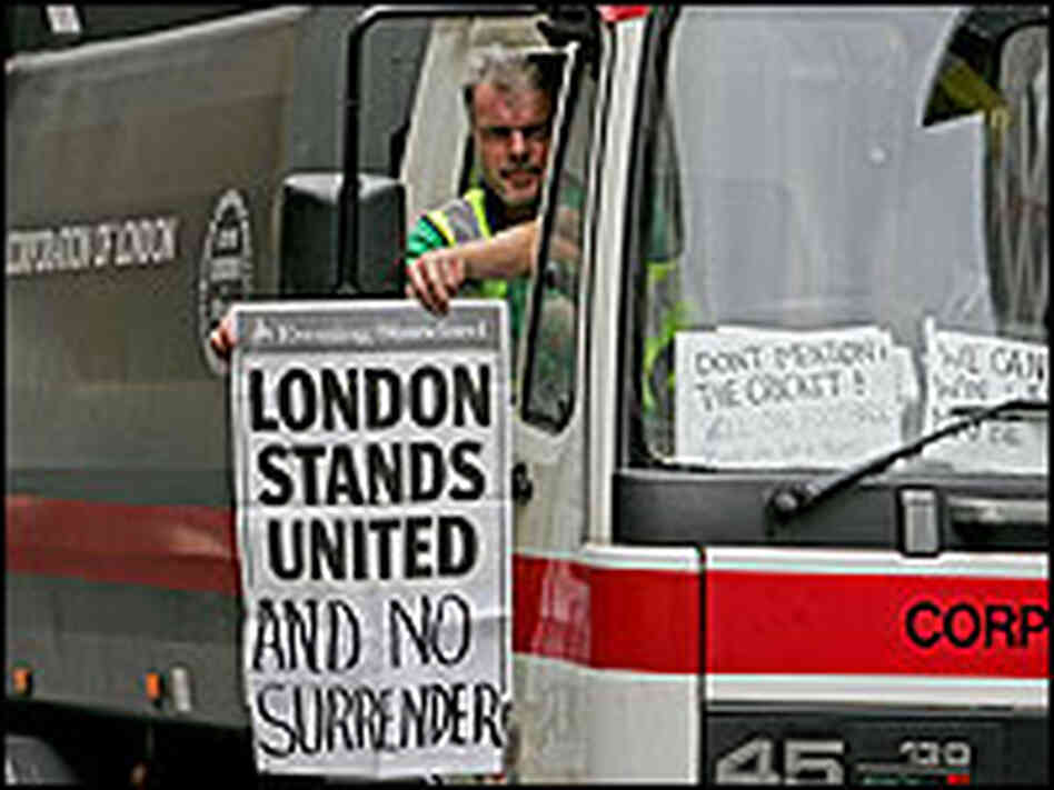 A London street cleaner displays a newspaper advertisement out of his lorry cab. A London street cleaner displays a newspaper advertisement out of his lorry cab.