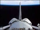 A view of Discovery's cargo bay over Earth's horizon. A view of Discovery's cargo bay over Earth's horizon.