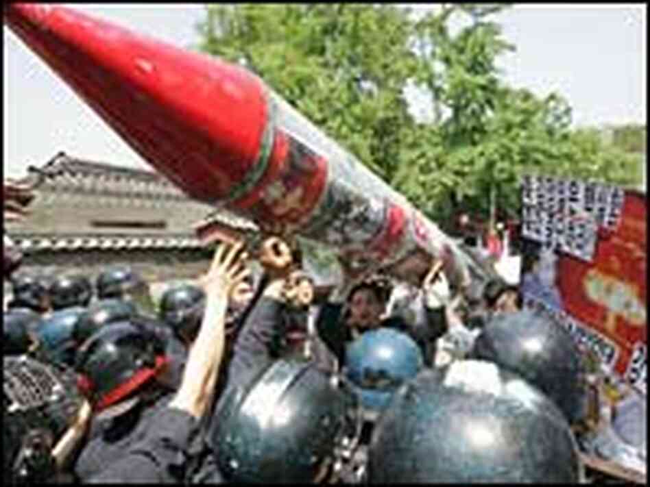 South Korean protesters carrying a mock North Korean missile South Korean protesters carrying a mock North Korean missile