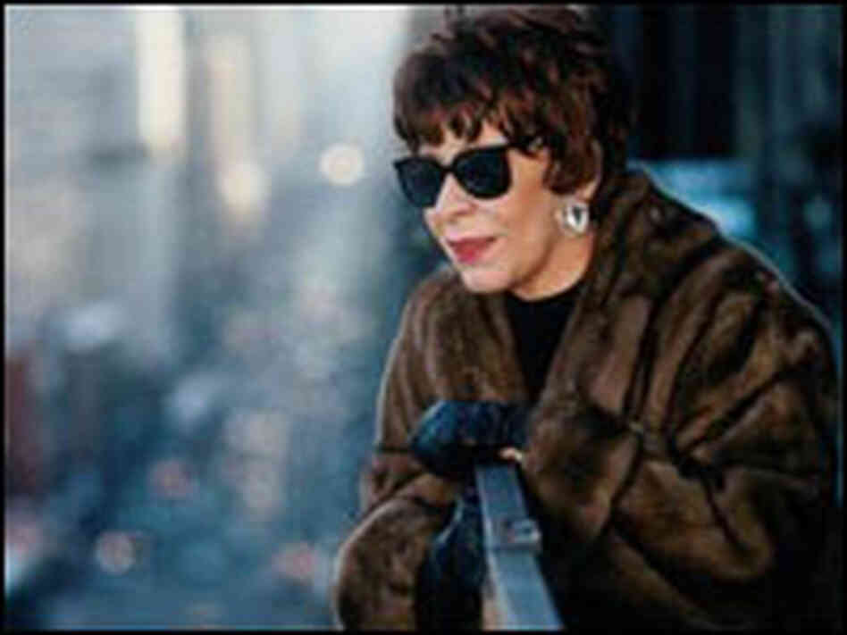 Shirley Horn, in sunglasses and fur coat, peers over a balcony railing. Shirley Horn, in sunglasses and fur coat, peers over a balcony railing.