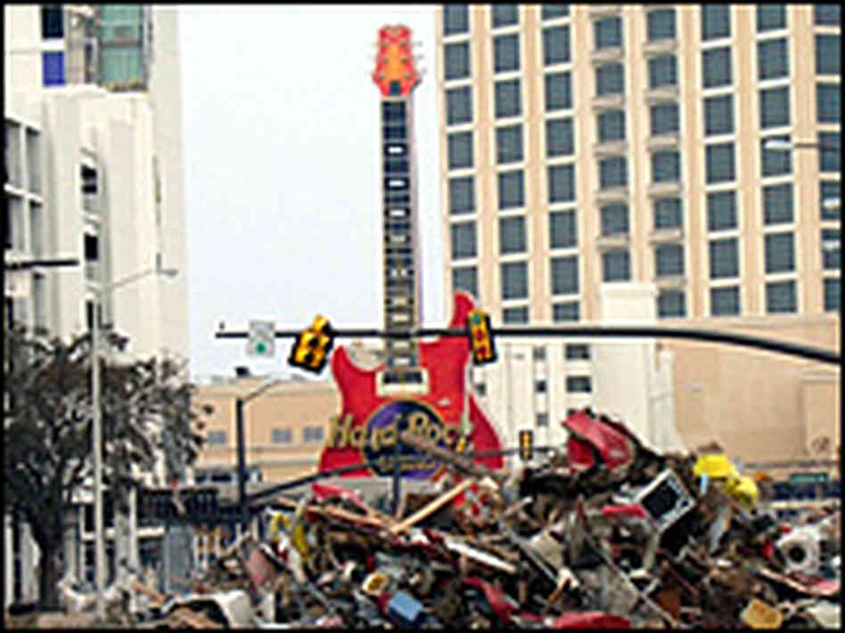 A towering red and purple guitar still stands in front of the remains of the Hard Rock Casino. A towering red and purple guitar still stands in front of the remains of the Hard Rock Casino.