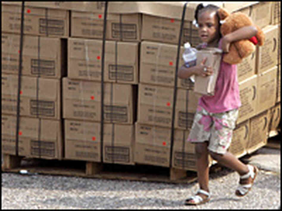 A young Hurricane Katrina survivor carries her food ration. A young Hurricane Katrina survivor carries her food ration.