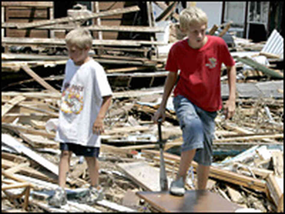 Two brothers look through debris as they help friends in Biloxi, Miss. Two brothers look through debris as they help friends in Biloxi, Miss.