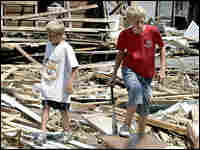 Two brothers look through debris as they help friends in Biloxi, Miss. Two brothers look through debris as they help friends in Biloxi, Miss.