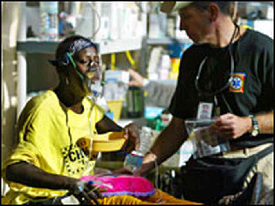 A woman receives oxygen and care at a triage unit in the airport A woman receives oxygen and care at a triage unit in the airport