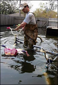 Mike Mire removes his children's bicycles from the garage of his house.