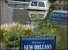 A welcome sign stands in a flooded street in downtown New Orleans. A welcome sign stands in a flooded street in downtown New Orleans.