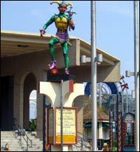 A statue of a jester is surrounded by litter near the ferry dock in the central business district.