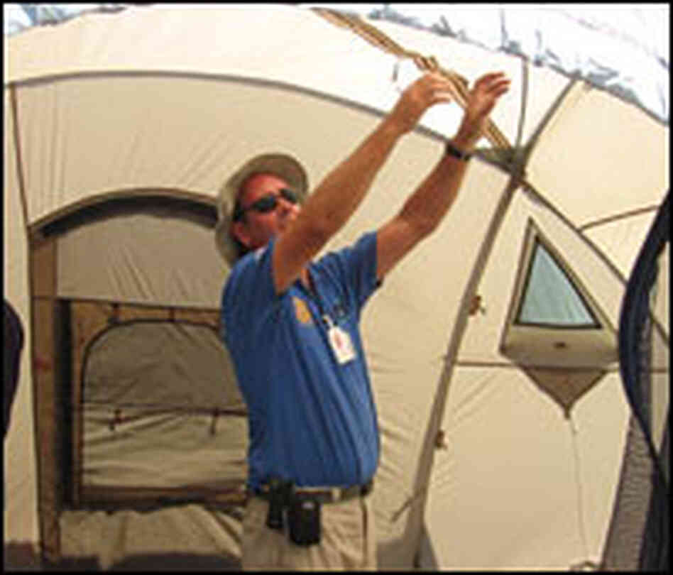 Green assembles a dome tent.
