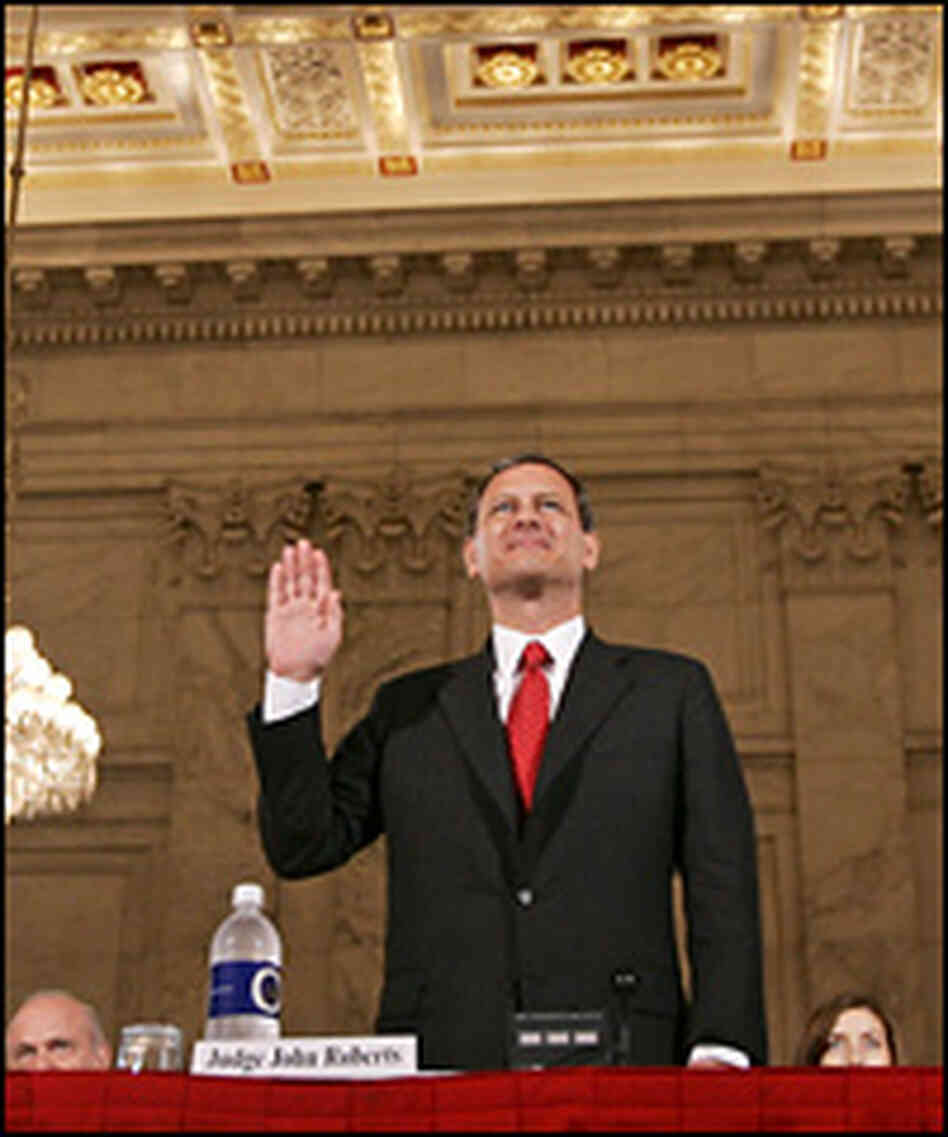 John Roberts, chief justice nominee, raises his right hand as he is sworn in to testify.