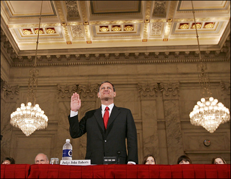 John Roberts, chief justice nominee, raises his right hand as he is sworn in to testify.