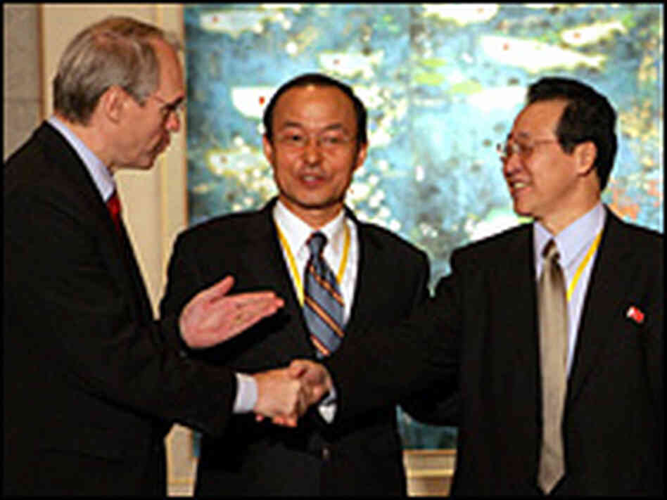 U.S. Assistant Secretary of State Christopher Hill (L) shakes hands with North Korea's chief negotia U.S. Assistant Secretary of State Christopher Hill (L) shakes hands with North Korea's chief negotia