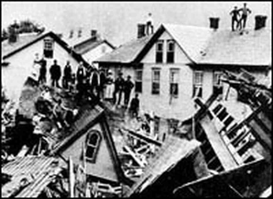 People stand amid the destruction in Johnstown. Credit: Johnstown Area Heritage Association.