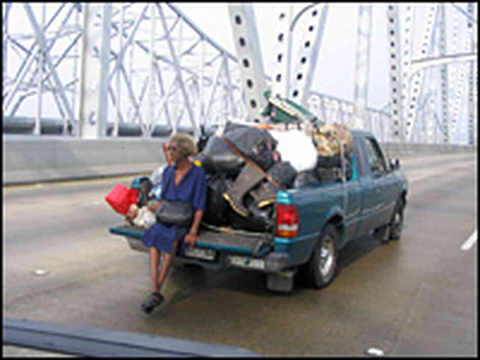 A woman sits on the rear of her truck on a bridge in the aftermath of Hurricane Katrina. A woman sits on the rear of her truck on a bridge in the aftermath of Hurricane Katrina.