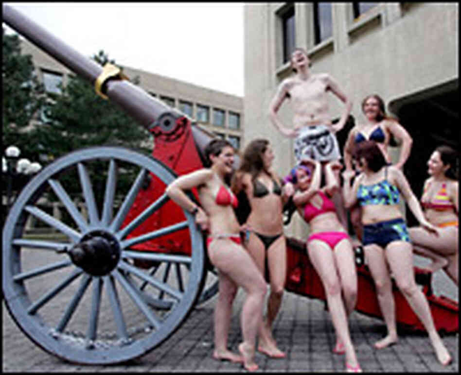 Bikini-clad MIT students gather around a cannon stolen from Caltech's campus.