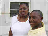 Nedra Alexis stands in front of her house with her son, Glenn. Nedra Alexis stands in front of her house with her son, Glenn.