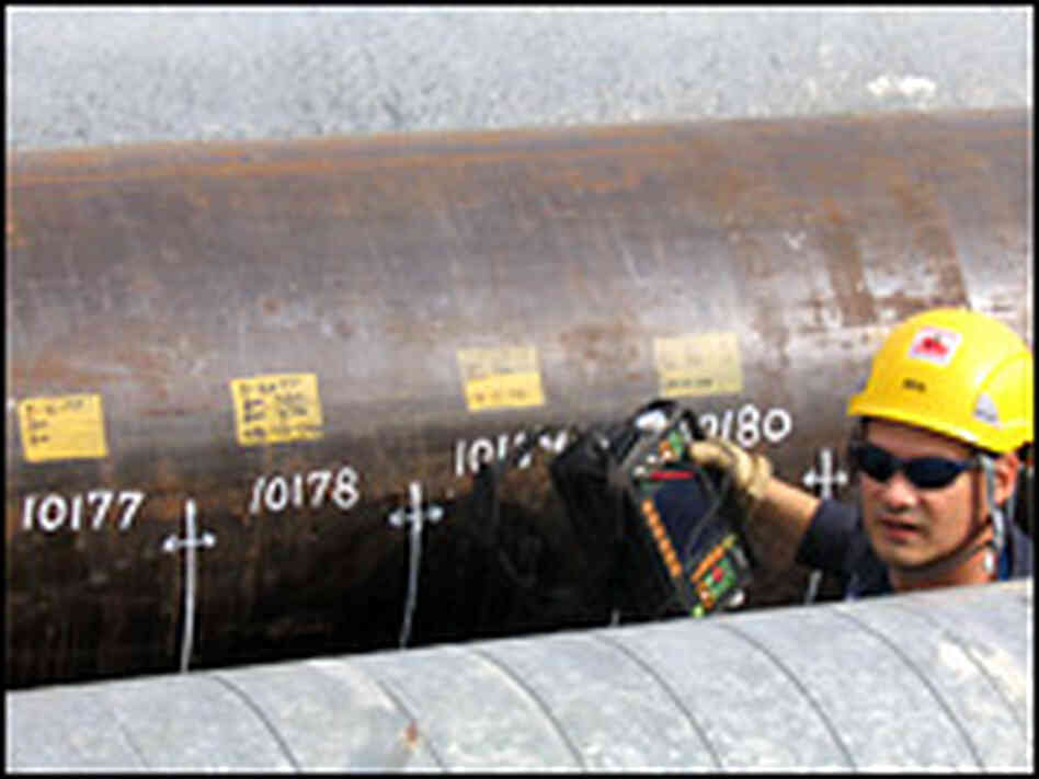 A surveyor records results from a pipeline sonogram. A surveyor records results from a pipeline sonogram.
