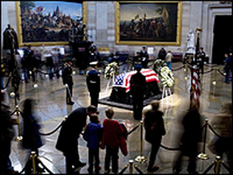 Visitors to the Capitol Rotunda pass by the flag-draped coffin of the 38th president.