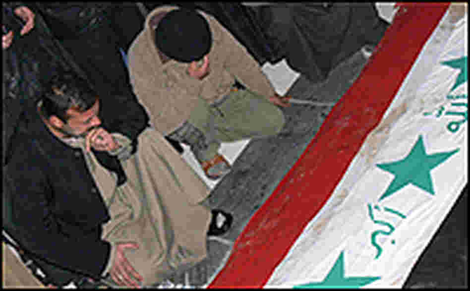 Iraqis grieve at the grave of ousted Iraqi dictator Saddam Hussein.