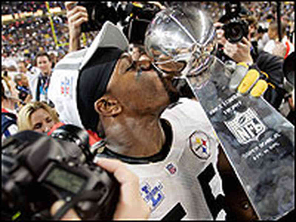 Joey Porter kisses the Vince Lombardi Trophy after the Super Bowl win.