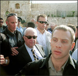 Sharon, surrounded by security personnel, leaves the Temple Mount in Jerusalem. Sharon, surrounded by security personnel, leaves the Temple Mount in Jerusalem.