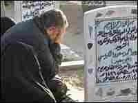 A man in Fallujah weeps at the grave of his loved one A man in Fallujah weeps at the grave of his loved one