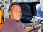 On Discovery's flight deck, shuttle commander Steven W. Lindsey preps for another day's work. On Discovery's flight deck, shuttle commander Steven W. Lindsey preps for another day's work.