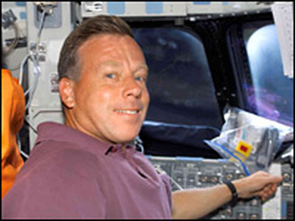 On Discovery's flight deck, shuttle commander Steven W. Lindsey preps for another day's work. On Discovery's flight deck, shuttle commander Steven W. Lindsey preps for another day's work.