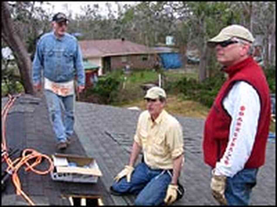 Volunteers Bill Hufnagel, Travis Brown and Bob Reklaitis help roof a home in Bay St. Louis