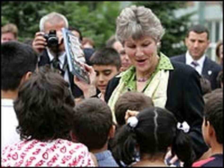 Karen Hughes hands out books to Turkish students in Istanbul.
