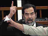 Saddam Hussein yells at the court as he receives his death sentence. Saddam Hussein yells at the court as he receives his death sentence.