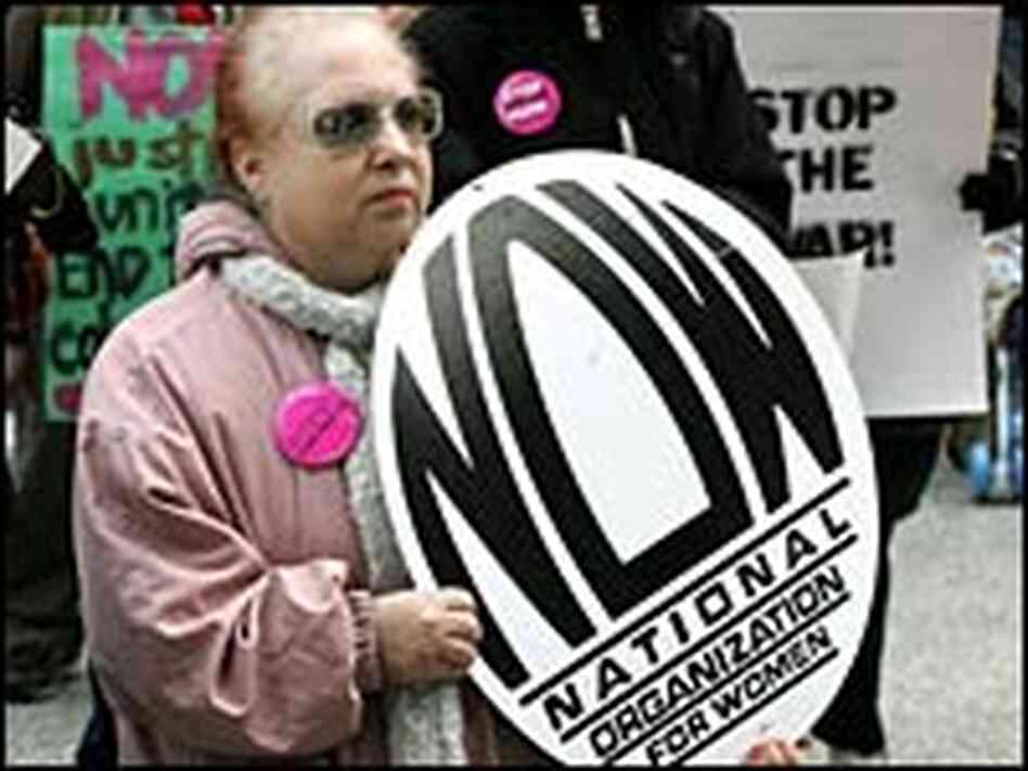 Rally participant Sue Straus holds a National Organization for Women sign Rally participant Sue Straus holds a National Organization for Women sign
