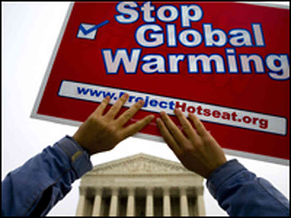 An environmental activist lifts a sign outside the Supreme Court, An environmental activist lifts a sign outside the Supreme Court,