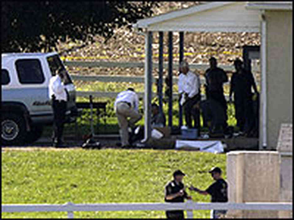 Investigators are seen at a school house, in which police say a gunman killed several people, in Nic Investigators are seen at a school house, in which police say a gunman killed several people, in Nic